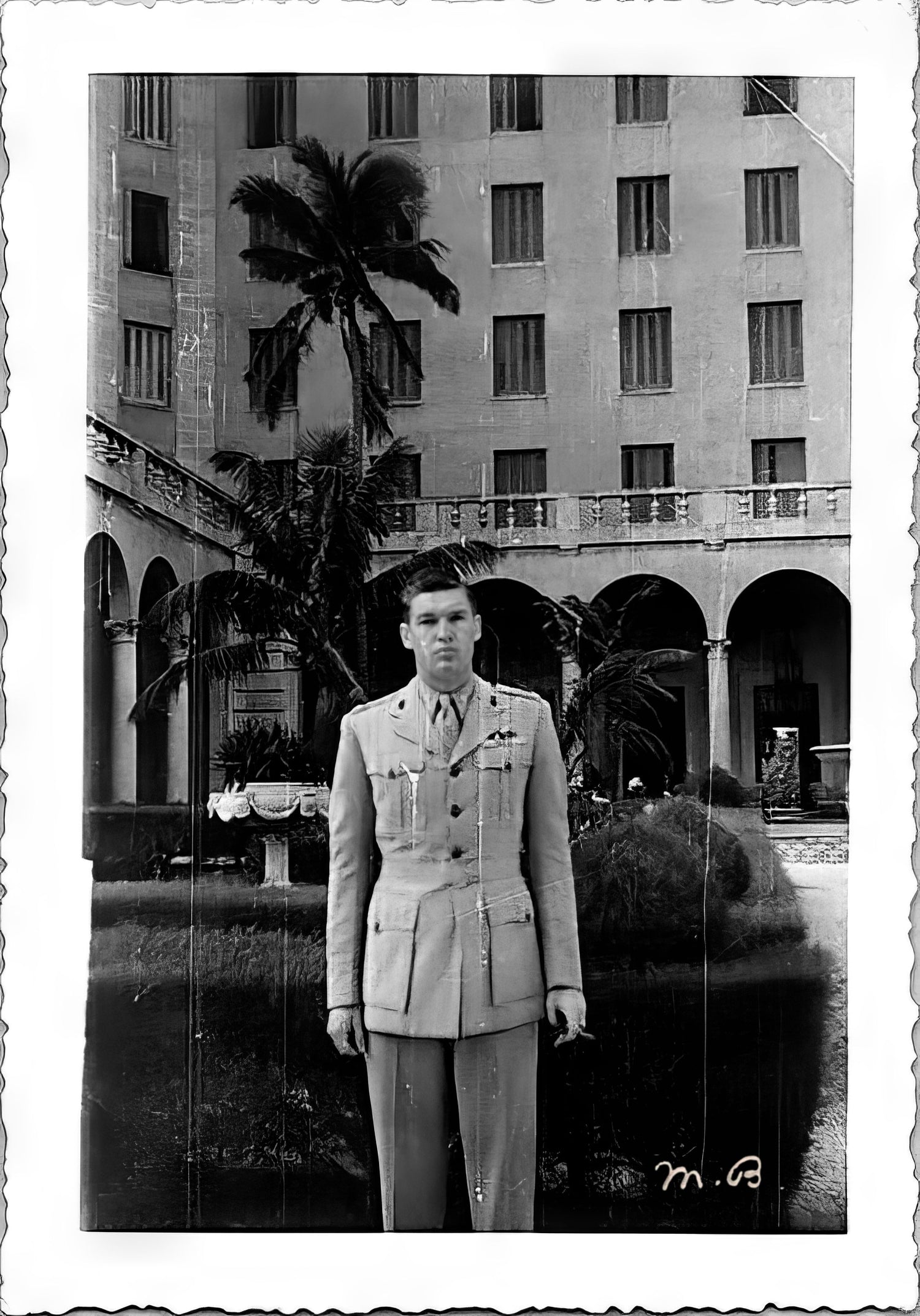 Major Leon Williamson stands in front of a tropical hotel entrance in Cuba